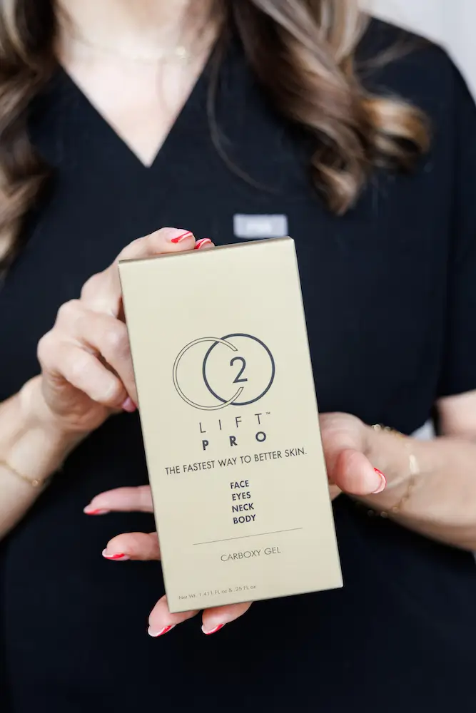 A person in a black outfit holds a box of "Lift Pro" skincare product, promising improved face, eyes, neck, and body appearance.