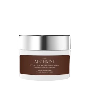 A white container labeled "Alchmst Even Tone Brightening Pads" with a metallic silver lid against a white background. Contains kojic acid, arbutin, and emblica.