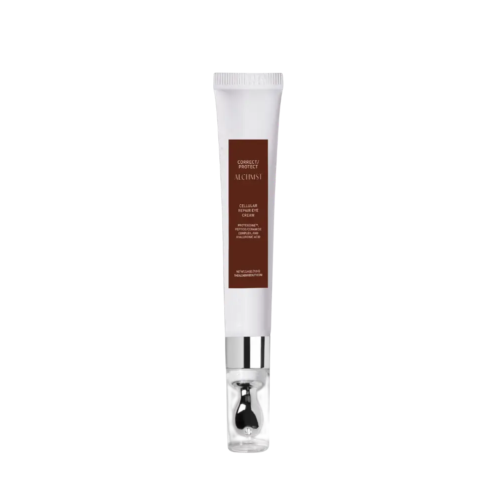 A white tube of "Correct/Protect Alchemist Cellular Repair Eye Cream" with metallic accents against a black background, showcasing skincare packaging design.