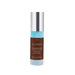 A cylindrical bottle labeled "ALCHMST Hyaluronic Acid Hydrating Serum" with a silver cap, featuring a brown and blue design.