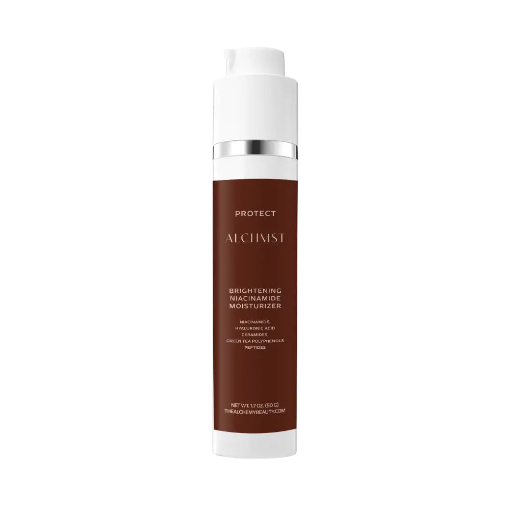 A cylindrical skincare product labeled "Alchemist Brightening Niacinamide Moisturizer" with brown packaging and silver accents, emphasizing protective and nourishing ingredients.