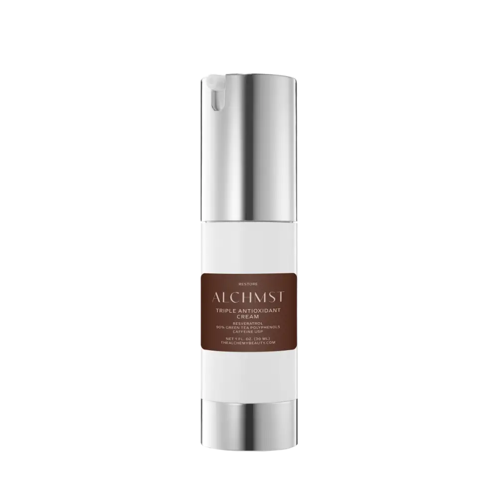 Sleek white and silver bottle labeled "ALCHMST Triple Antioxidant Cream," featuring resveratrol and polyphenols, against a plain black background.